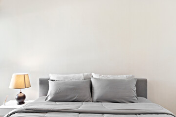 gray bed and lamp
