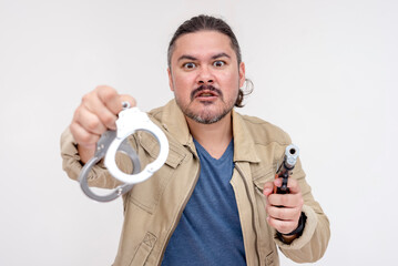 A crooked criminal threatens someone to put on handcuffs with a gun pointed at him. Isolated on a...