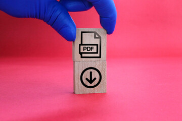 wooden square with PDF format file icon and download. the concept of saving a pdf file. concept pdf...