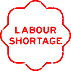 Fototapeta premium Grunge red labour shortage word rubber seal stamp on wthie background