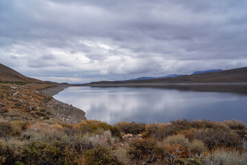 Panoramic view of the Grant lake on the June Lake Loop in Sierra Nevada, Mono County, California, USA. Hiking trail along the lakeshore on a rainy day. Remote travel destination for nature lovers