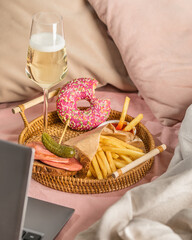 person with champagne and laptop