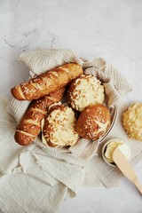Closeup of delicious Laugen buns with salt and butter on a white table