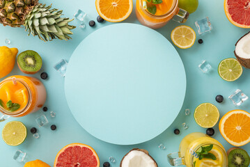 Get a taste of paradise with this tropical-inspired top view photo of fruity cocktails in glass jars, complete with orange, lemon, lime grapefruit slices on blue backdrop and a blank space for text