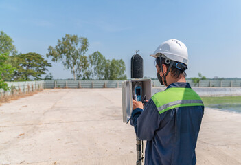 Environmental officer setting sound level meter for monitor.