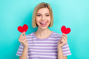 Photo of young satisfied coquette girlfriend blonde hair hold miniature heart postcard lick teeth...