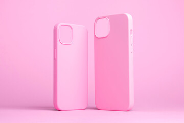 set of two pink cases for iPhone 15 and 14 Plus or iPhone 13 and 13 mini back side view isolated on...