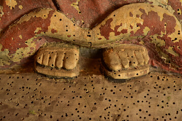 Close-up of the feet of a medieval figure of a saint.