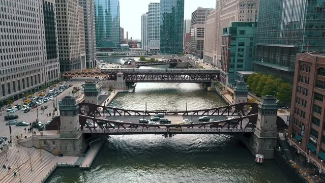 CHICAGO, USA - APRIL, 2023: Aerial drone footage of Chicago river and Downtown with skyscraper on cinematic background. Financial and residential buildings cityscape view on sunny spring day.