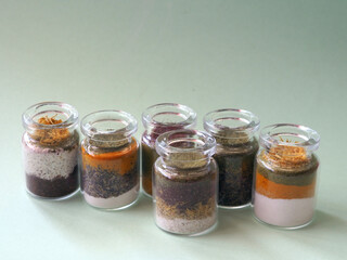 Different ayurvedic cosmetic ubtan for face and hair care on glass bottles