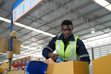 Fototapeta na wymiar Multiethnic industrial workers checking their logistic lists while working with transportation of goods in warehouse