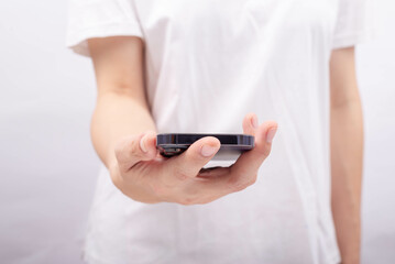 Female hand on smartphone shown above.