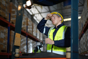 Man forklift driver working in a warehouse.