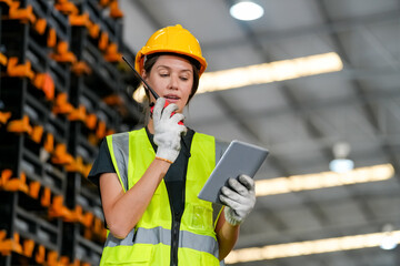 woman worker or supervisor controlling stock in a warehouse.