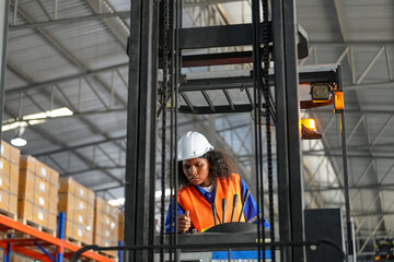 Female forklift driver working in a warehouse.