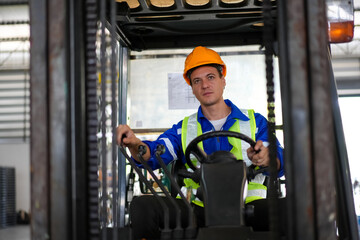 Man forklift driver working in a warehouse.