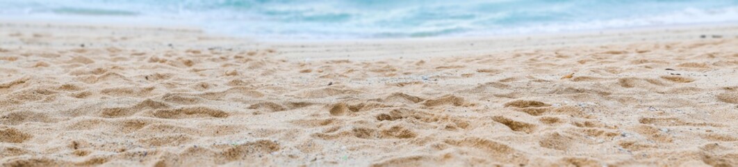 Fototapeta na wymiar Panoramic view of sand on the beach background 