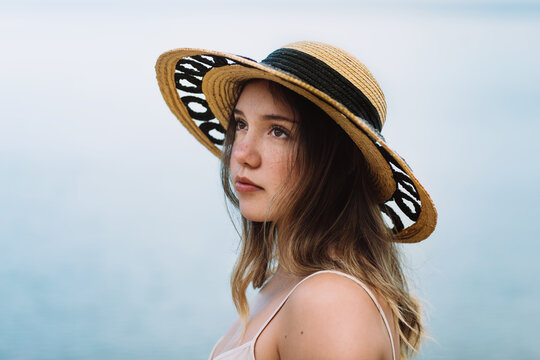 Woman in sunhat admiring seascape