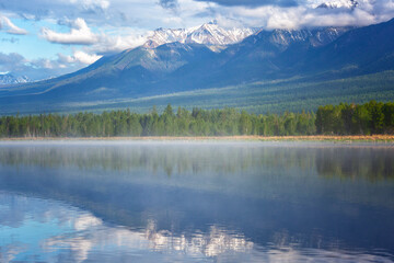 Russia. Landscape with mountains reflecting in the water on summer day. Buryatia, Tunkinskaya valley