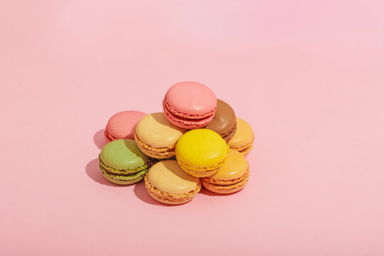 Set of colorful macaroons on pink background