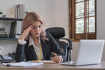 tired business woman sleepy and bored from sitting at a desk for a long time and has office syndrome