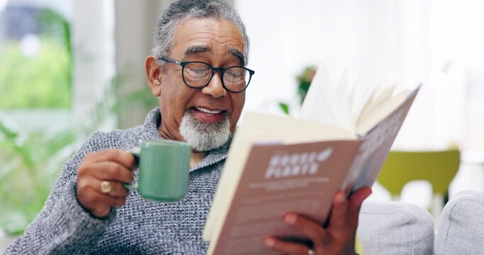 Senior man, coffee and reading book in living room, home and smile for story, novel and knowledge. Happy old guy drinking cup of tea with books in lounge for retirement, literature and hobby to relax