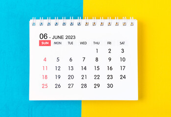 The June 2023 Monthly desk calendar for 2023 year on blue and yellow background. - obrazy, fototapety, plakaty