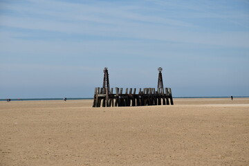 Old wooden pier On St Anne's beach in Lytham Lancashire England. Blue sky background and no people. 