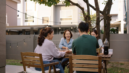Mom enjoy cooking for family day dining at dine table cozy patio front yard home. Mum passing food...