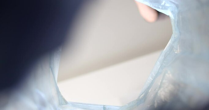 Man throwing crumpled paper into trash bin bottom view 4k movie slow motion. Waste sorting concept