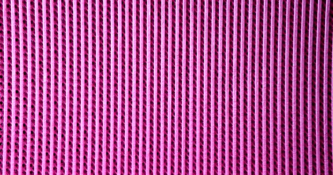 Pink rubber mat with parallel lines background closeup 4k movie slow motion. Abstract patterns for design concept 