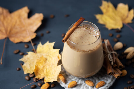 horchata coffee with almonds and cinnamon on a table with autumn yellow leaves