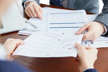 Businessmen exchange one of the contracts on the table