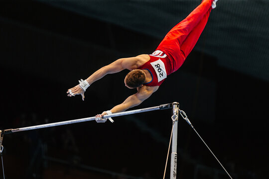 athlete gymnast exercise on horizontal bar in gymnastics summer games, apparatus company Spieth Germany