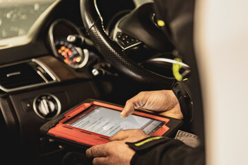 Mechanic Running Diagnostics on Modern Car Computer