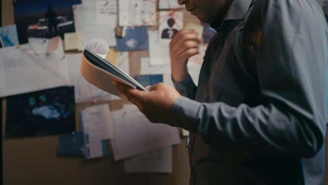 Police detective checking evidence list, looking for killer, investigation