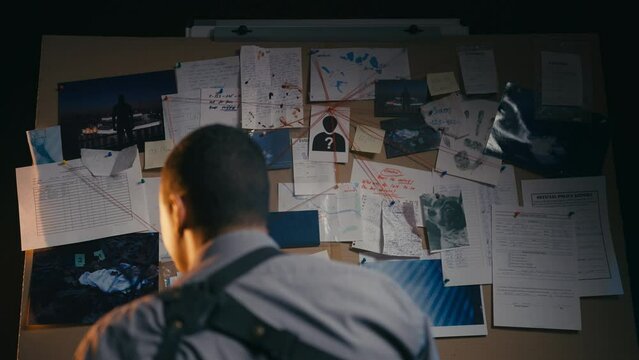 African American detective trying to solve murder using logical thinking, clues