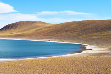 Amazing deep blue lagoon of Laguna Miniques, located in the altiplano of Antofagasta region, Los Flamencos national reserve,  Chile, South America