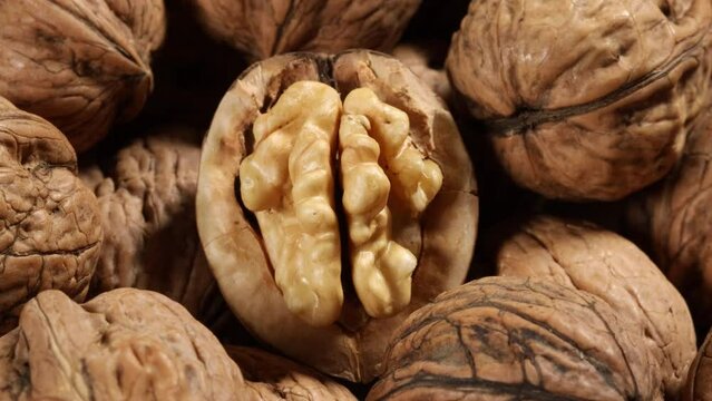 traveling dolly shot closeup on an open walnut on a heap of walnuts
