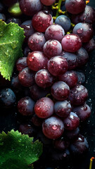 Fresh Grapes background, adorned with glistening droplets of water, top down view.