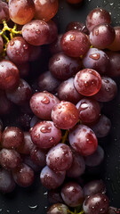 Fresh Grapes background, adorned with glistening droplets of water, top down view.