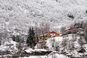 Snowy Mountains and Colorful Buildings in Flam, Norway