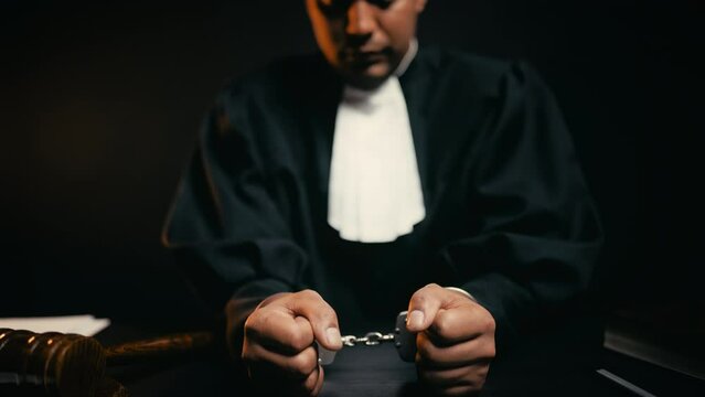Corrupt judge sitting cuffed in the courtroom, judicial system failure