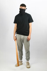 Teen boy with a baseball bat mask white background