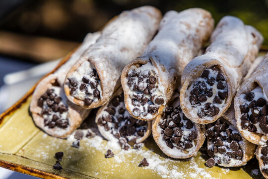 Close up of fancy cannoly pastries served at and outdoor buffet