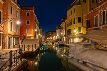 Fototapeta na wymiar Typical Venetian canal with bridge at night, Venice, Italy