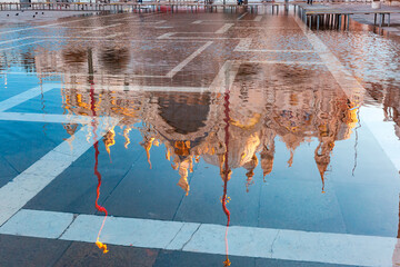 Piazza San Marco, St Mark Square at sunrise, deluged by flood water during High water, Venice, Italy