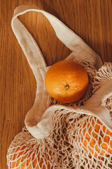 oranges in cotton bag vertical format