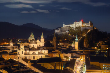 Obraz premium City view of Slazburg at night with the Hohensalzburg fortress in the background and the Salzburg cathedral. famous tourist destination the birthplace of Mozart.
