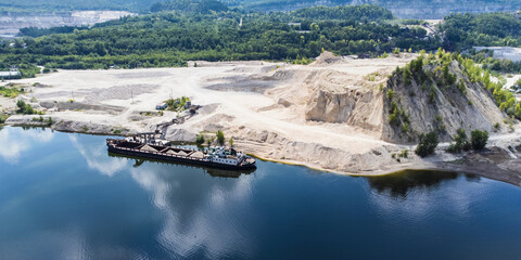 Aerial view of the loading of dry cargo ships with bulk building materials.
